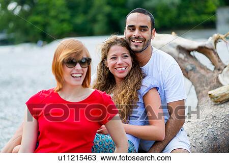 Three friends sitting on log View Large Photo Image Stock Image - Three friends sitting on log. Fotosearch