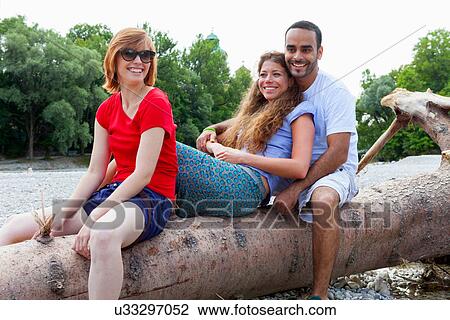 Three friends sitting on log View Large Photo Image Stock Image - Three friends sitting on log. Fotosearch