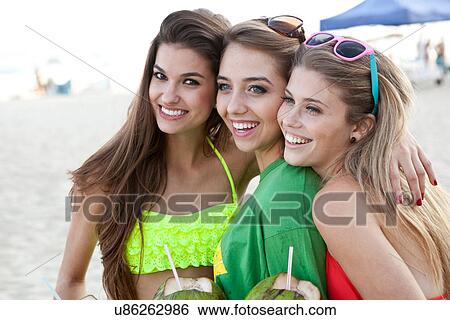 Three young female friends at the beach View Large Photo Image Stock Photograph - Three young female friends at the beach. Fotosearch
