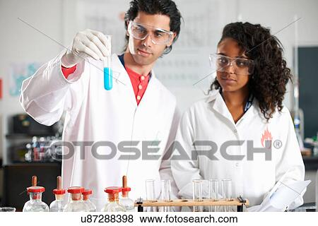 Two chemistry students doing experiment View Large Photo Image Stock Photo - Two chemistry students doing experiment. Fotosearch