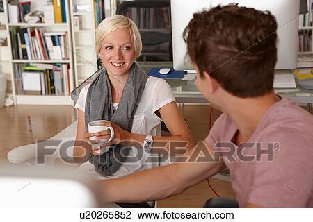 Two colleagues talking, woman with coffee View Large Photo Image Stock Image - Two colleagues talking, woman with coffee. Fotosearch
