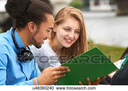 Two college students reading book View Large Photo Image Stock Image - Two college students reading book. Fotosearch