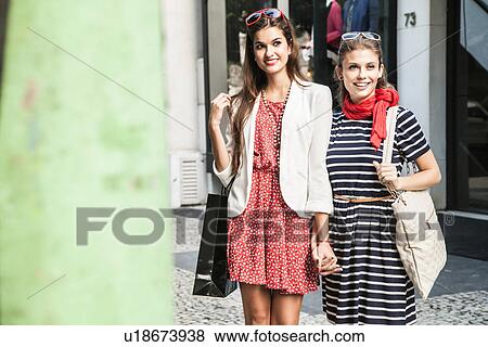 Stock Photo - Two female friends holding hands. Fotosearch