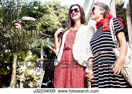 Two female friends holding hands View Large Photo Image Stock Photo - Two female friends holding hands. Fotosearch