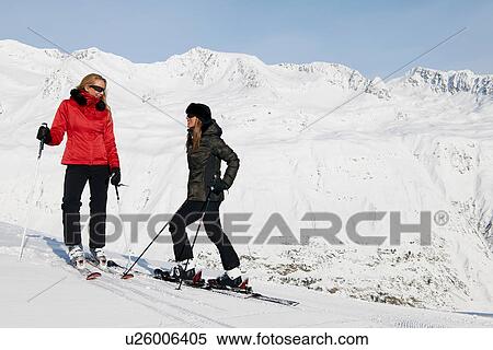 Stock Photography - Two female skiers talking, Obergurgl, Austria. Fotosearch
