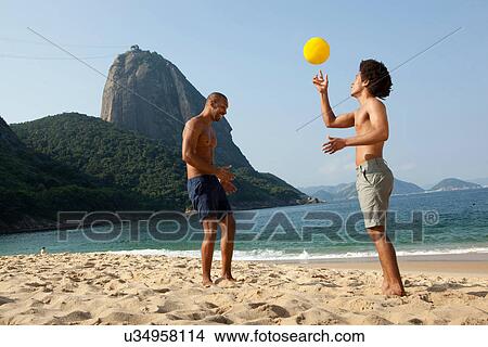 Two friends on beach with volleyball, Rio de Janeiro, Brazil View Large Photo Image Picture - Two friends on beach with volleyball, Rio de Janeiro, Brazil. Fotosearch