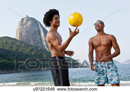 Two friends on beach with volleyball, Rio de Janeiro, Brazil View Large Photo Image Stock Photo - Two friends on beach with volleyball, Rio de Janeiro, Brazil. Fotosearch