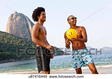 Two friends on beach with volleyball, Rio de Janeiro, Brazil View Large Photo Image Stock Photography - Two friends on beach with volleyball, Rio de Janeiro, Brazil. Fotosearch