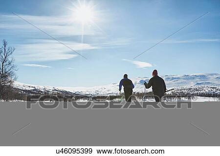 Stock Photo - Two senior men cross country skiing, Hermavan, Sweden. Fotosearch