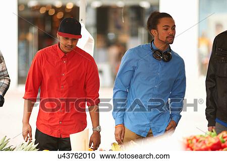 Stock Image - Two teenage boys at market. Fotosearch