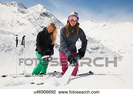 Stock Image - Two woman in snow with skis, Obergurgl, Austria. Fotosearch