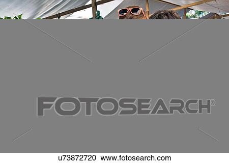 Stock Image - Two women buying fresh vegetables in market. Fotosearch