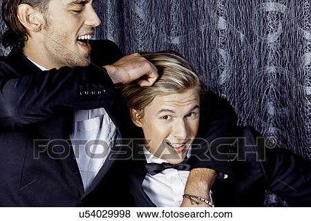 Two young men fun fighting View Large Photo Image Stock Photo - Two young men fun fighting. Fotosearch