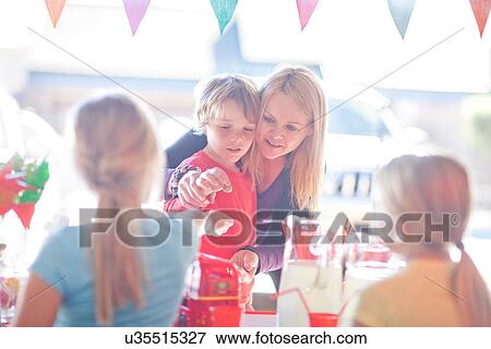 Two young sisters selling drink to brother and mother View Large Photo Image Stock Photo - Two young sisters selling drink to brother and mother. Fotosearch