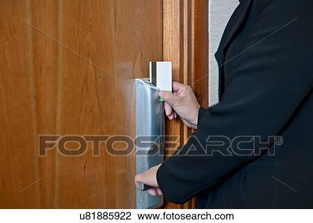 Woman accessing hotel room with keycard View Large Photo Image Stock Image - Woman accessing hotel room with keycard. Fotosearch