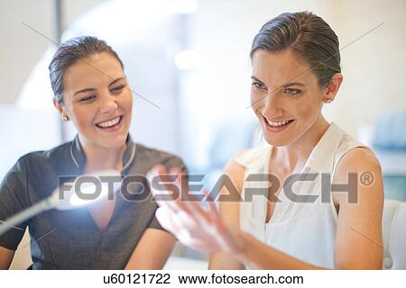 Stock Image - Woman admiring her fingernails after beauty treatment. Fotosearch