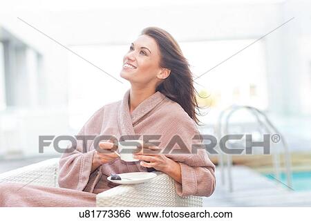 Woman at hotel poolside drinking coffee View Large Photo Image Stock Photograph - Woman at hotel poolside drinking coffee. Fotosearch