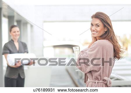 Woman at hotel poolside holding glass of champagne View Large Photo Image Stock Image - Woman at hotel poolside holding glass of champagne. Fotosearch