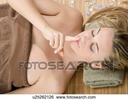 Woman at spa with finger on lips View Large Photo Image Stock Photograph - Woman at spa with finger on lips. Fotosearch