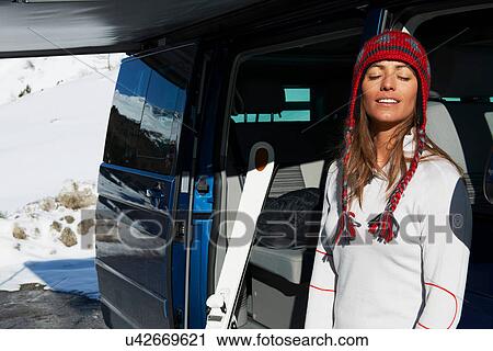 Woman by car with eyes closed View Large Photo Image Stock Image - Woman by car with eyes closed. Fotosearch