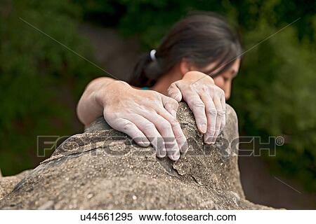 Woman hanging on to sandstone View Large Photo Image Stock Photography - Woman hanging on to sandstone. Fotosearch