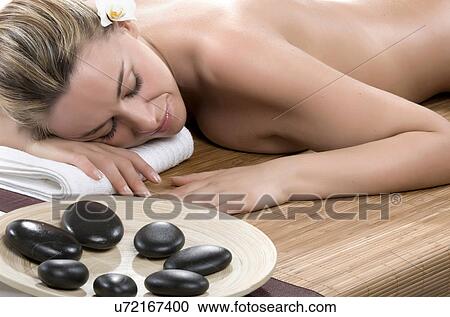 Woman having hot stone therapy with eyes closed View Large Photo Image Stock Image - Woman having hot stone therapy with eyes closed. Fotosearch