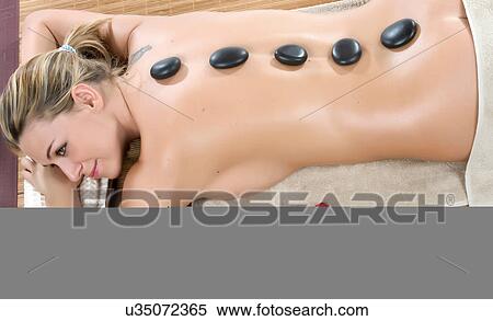 Woman having hot stone therapy with rose petals View Large Photo Image Stock Photography - Woman having hot stone therapy with rose petals. Fotosearch