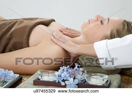 Stock Photo - Woman having shoulder massage at spa. Fotosearch