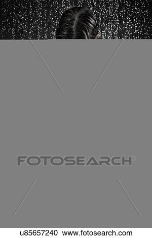 Stock Image - Woman in drenched shirt under shower. Fotosearch