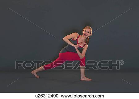 Woman in yoga pose on grey background View Large Photo Image Stock Image - Woman in yoga pose on grey background. Fotosearch