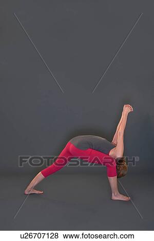 Stock Photo - Woman in yoga pose on grey background. Fotosearch