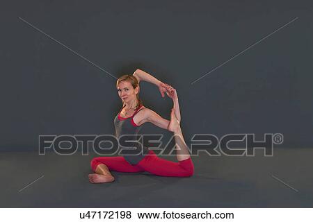 Woman in yoga pose on grey background View Large Photo Image Stock Photo - Woman in yoga pose on grey background. Fotosearch
