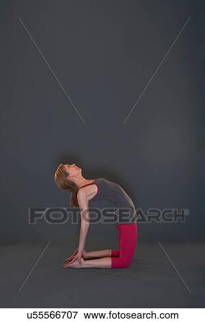 Woman in yoga pose on grey background View Large Photo Image Stock Photo - Woman in yoga pose on grey background. Fotosearch