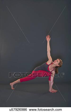 Woman in yoga pose on grey background View Large Photo Image Stock Photograph - Woman in yoga pose on grey background. Fotosearch