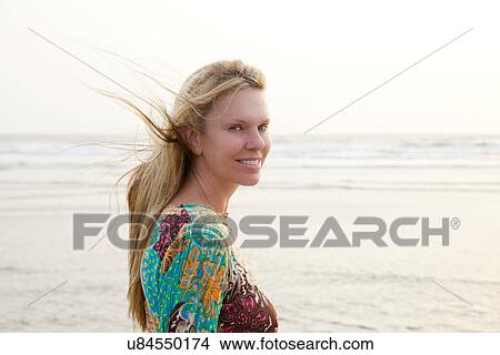 Woman looking sideways at camera View Large Photo Image Picture - Woman looking sideways at camera. Fotosearch