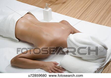 Woman lying in spa with towel covering head View Large Photo Image Stock Image - Woman lying in spa with towel covering head. Fotosearch