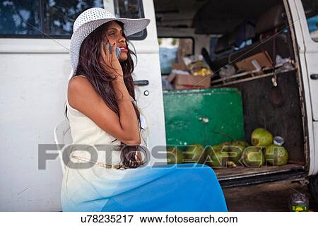 Woman on cell phone by campervan View Large Photo Image Stock Photo - Woman on cell phone by campervan. Fotosearch