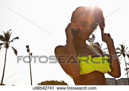 Woman on cell phone touching hair, Rio de Janeiro, Brazil View Large Photo Image Stock Image - Woman on cell phone touching hair, Rio de Janeiro, Brazil. Fotosearch