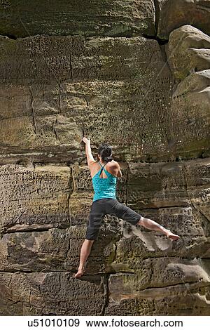 Woman on top rope climbing sandstone butte View Large Photo Image Stock Photo - Woman on top rope climbing sandstone butte. Fotosearch