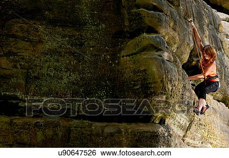 Woman on top rope climbing sandstone butte View Large Photo Image Stock Photograph - Woman on top rope climbing sandstone butte. Fotosearch
