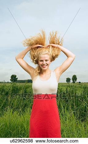 Woman throwing hair back View Large Photo Image Stock Photo - Woman throwing hair back. Fotosearch