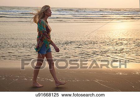 Woman walking on beach View Large Photo Image Stock Photography - Woman walking on beach. Fotosearch