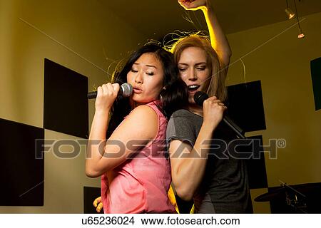 Picture - Women dancing and singing. Fotosearch
