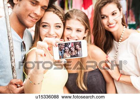 Young adults photographing themselves View Large Photo Image Stock Photo - Young adults photographing themselves. Fotosearch