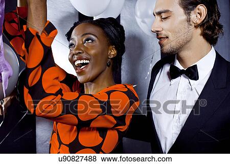 Stock Photo - Young couple dancing in nightclub. Fotosearch