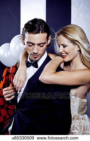 Stock Photo - Young couple dancing together in nightclub. Fotosearch