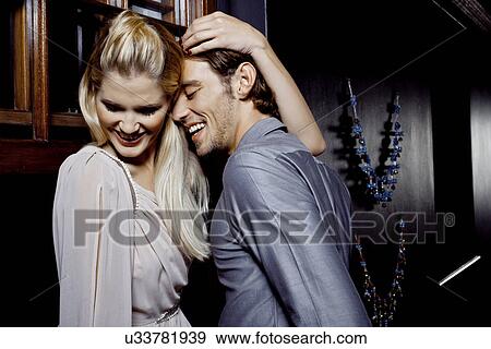 Stock Photo - Young couple flirting in nightclub. Fotosearch