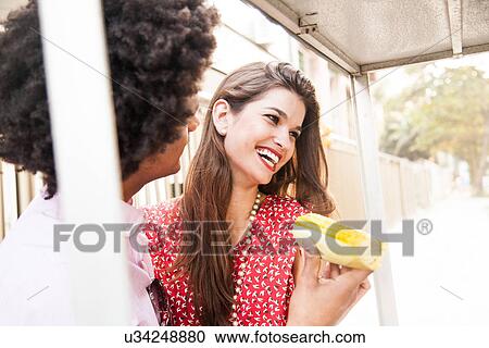 Young couple having sweetcorn snack View Large Photo Image Stock Image - Young couple having sweetcorn snack. Fotosearch