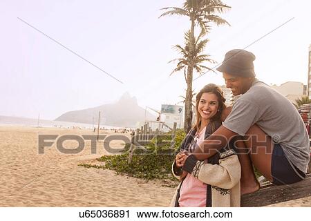Stock Image - Young couple on Ipanema Beach, Rio de Janeiro, Brazil. Fotosearch