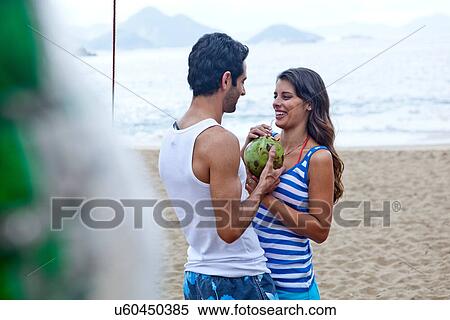 Young couple sharing coconut drink View Large Photo Image Stock Photography - Young couple sharing coconut drink. Fotosearch
